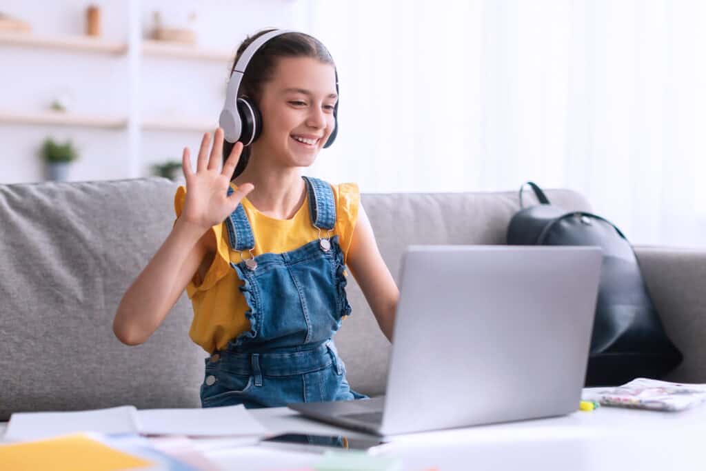 Meeting virtual learning girl smiling on laptop at home, Bradford International Virtual School, online education, remote learning, digital classroom.