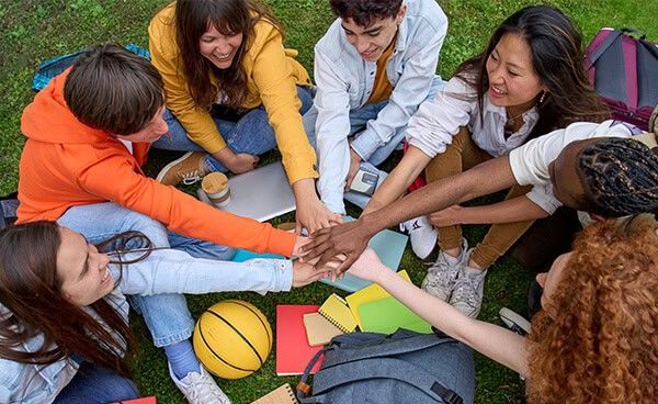 Friendly diverse students collaborating outdoors for virtual school learning Bradford International Virtual School education.